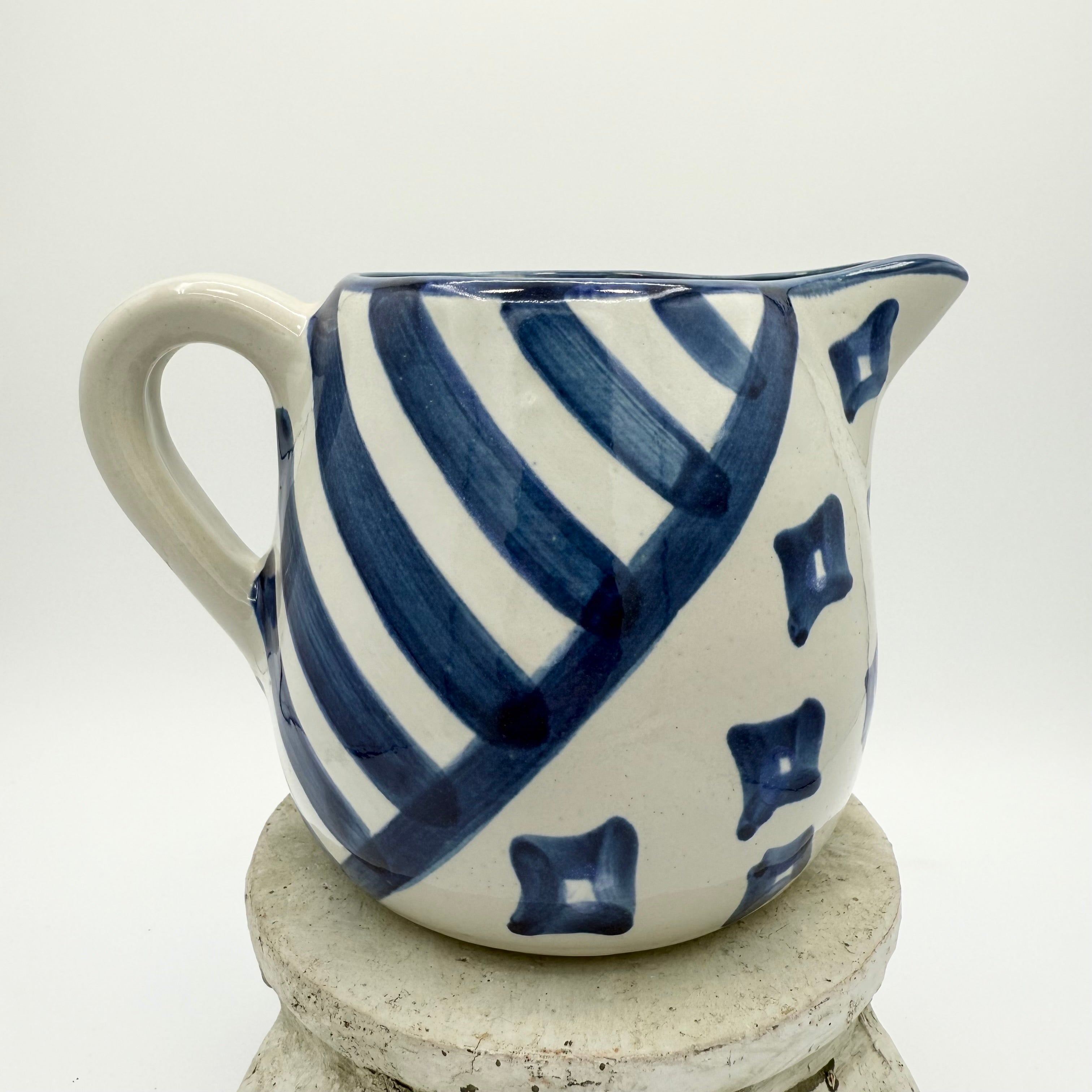 Vintage Louisville Stoneware pitcher with hand-painted blue geometric patterns. Made in Kentucky, USA. Excellent collectible.