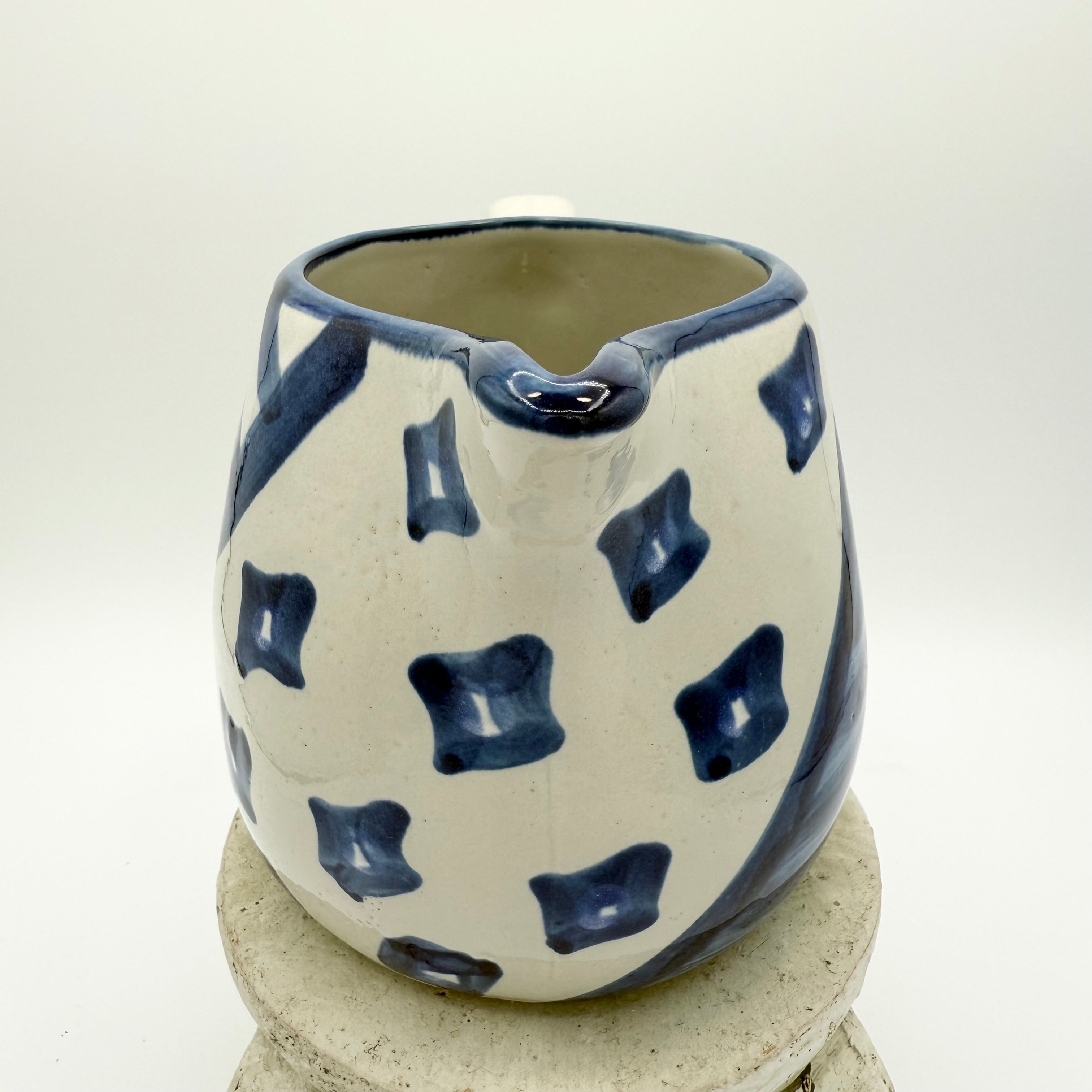 Vintage Louisville Stoneware pitcher with hand-painted blue geometric patterns. Made in Kentucky, USA. Excellent collectible.