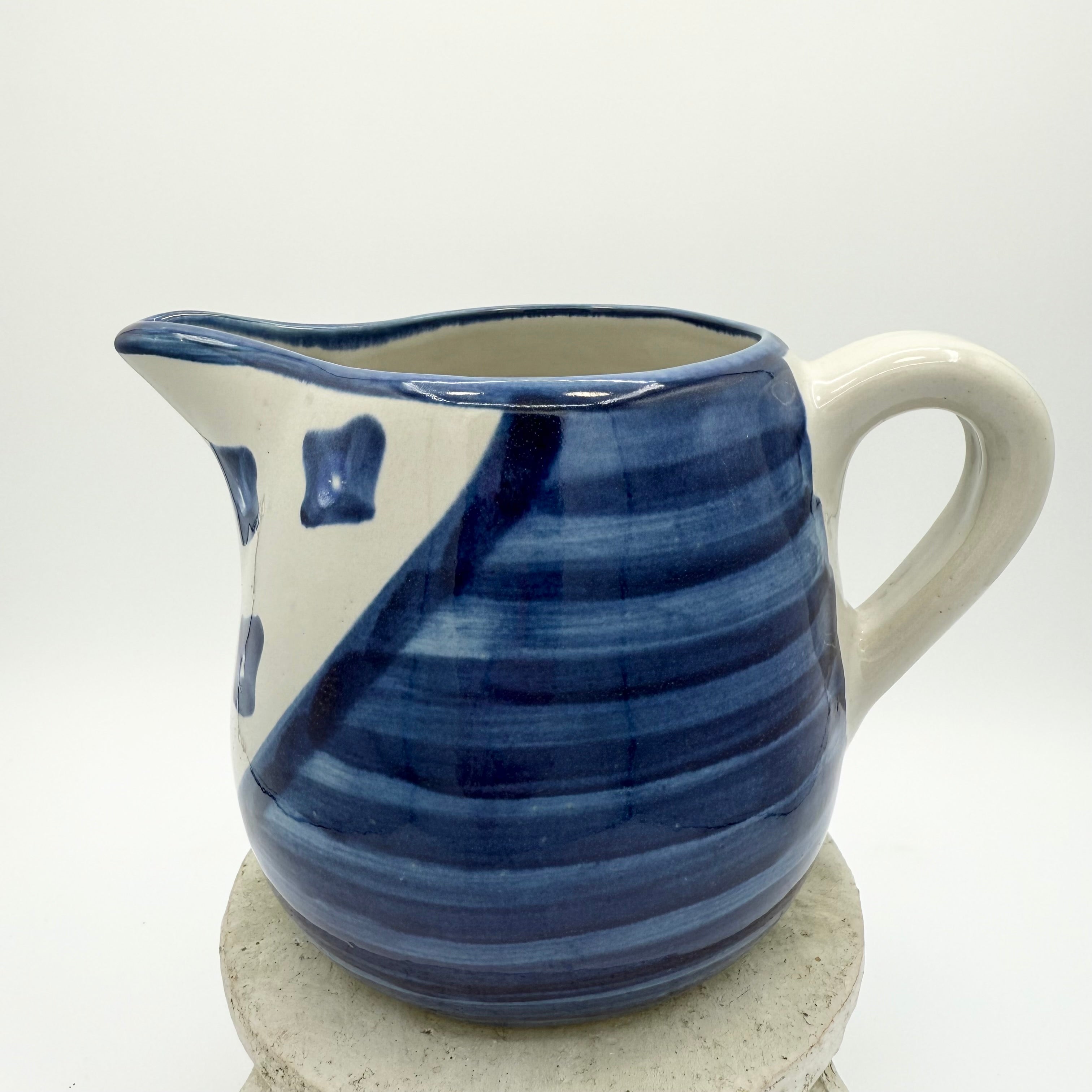 Vintage Louisville Stoneware pitcher with hand-painted blue geometric patterns. Made in Kentucky, USA. Excellent collectible.