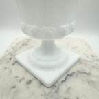 Vintage white milk glass urn with Greek key and leaf motif. Elegant pedestal vase collectible in excellent condition.