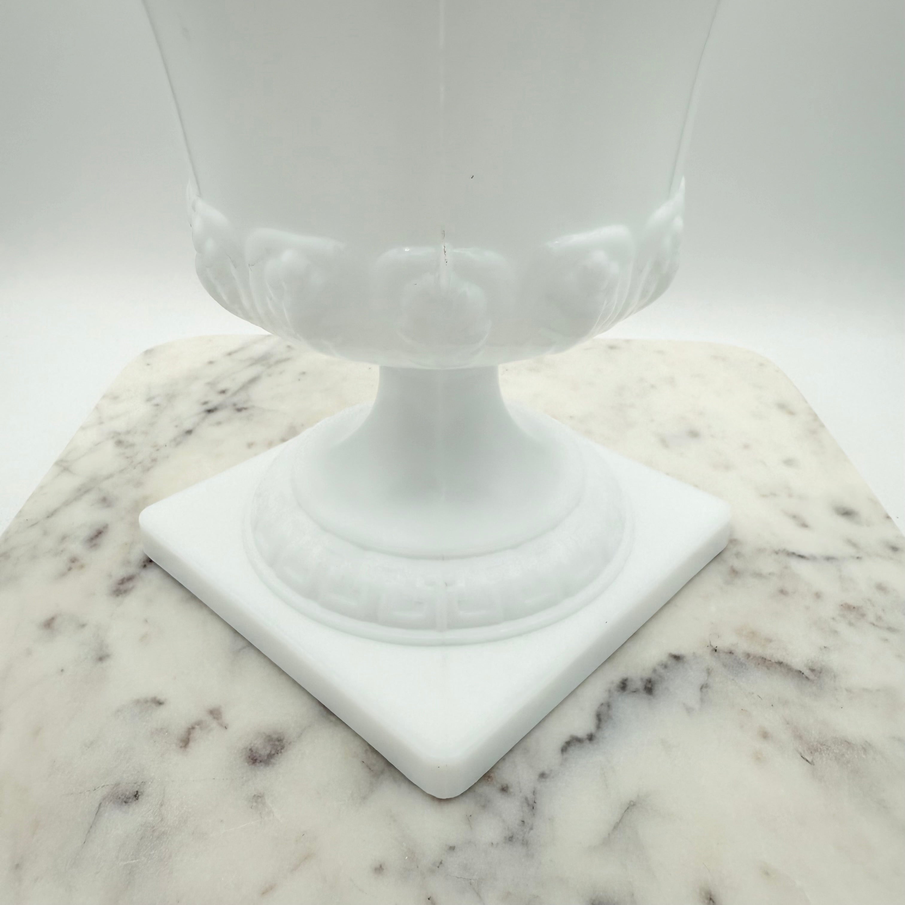 Vintage white milk glass urn with Greek key and leaf motif. Elegant pedestal vase collectible in excellent condition.