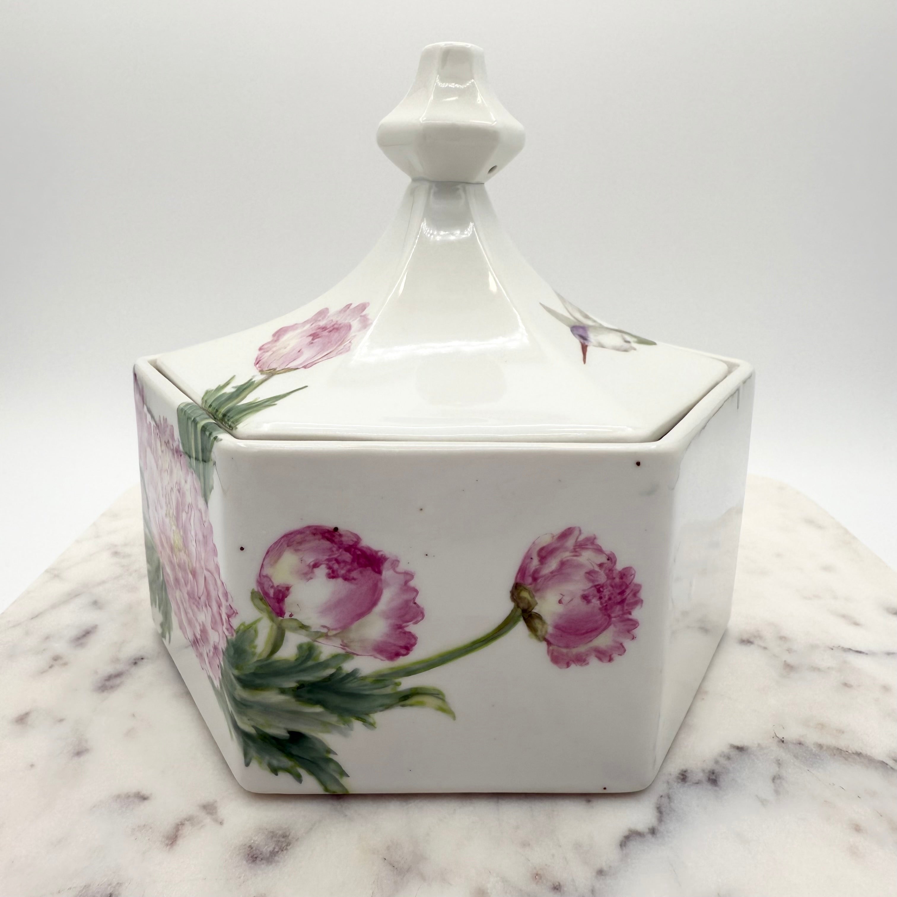Vintage ceramic lidded box with hand painted peony blossoms. Elegant floral collectible for display or storage.