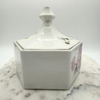 Vintage ceramic lidded box with hand painted peony blossoms. Elegant floral collectible for display or storage.