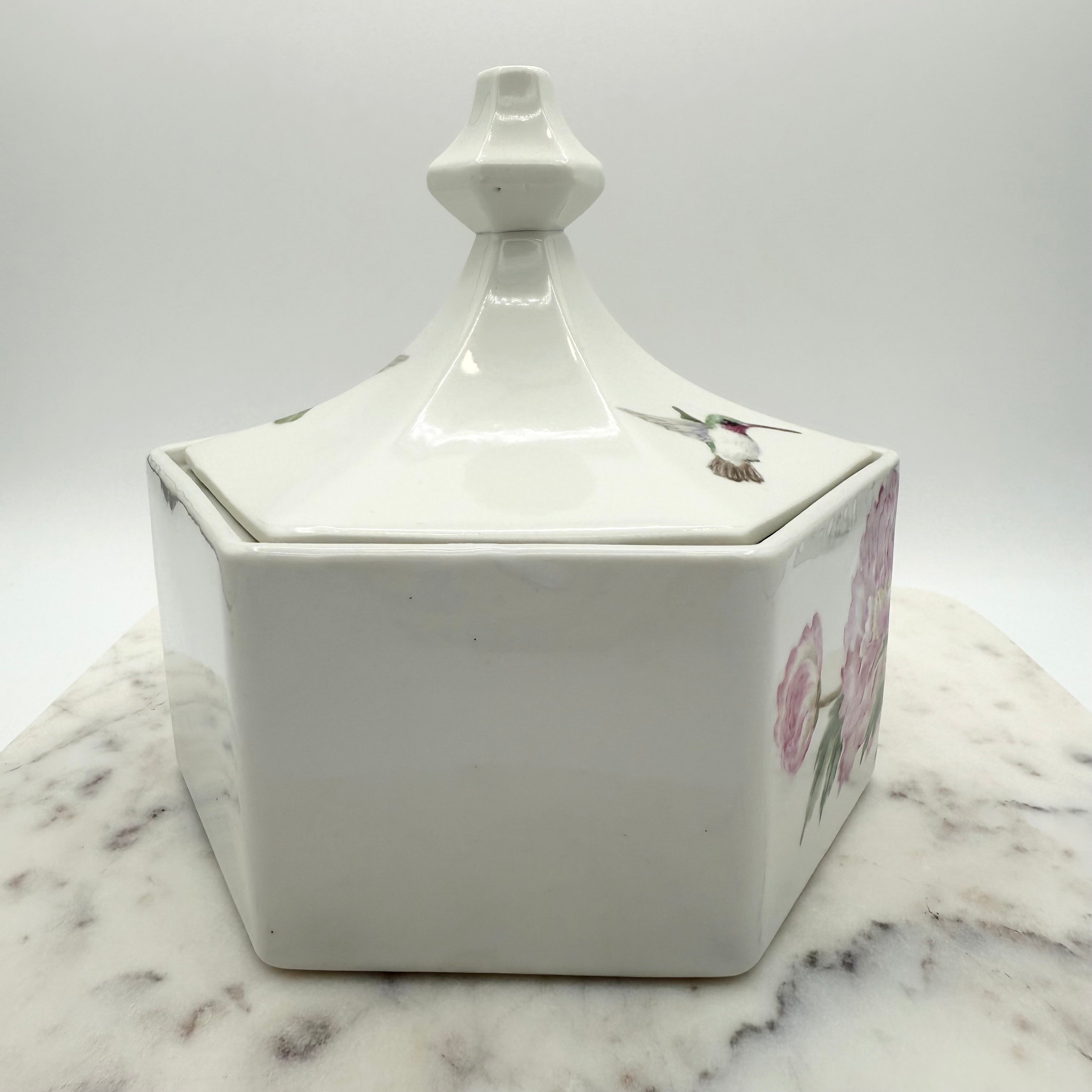 Vintage ceramic lidded box with hand painted peony blossoms. Elegant floral collectible for display or storage.