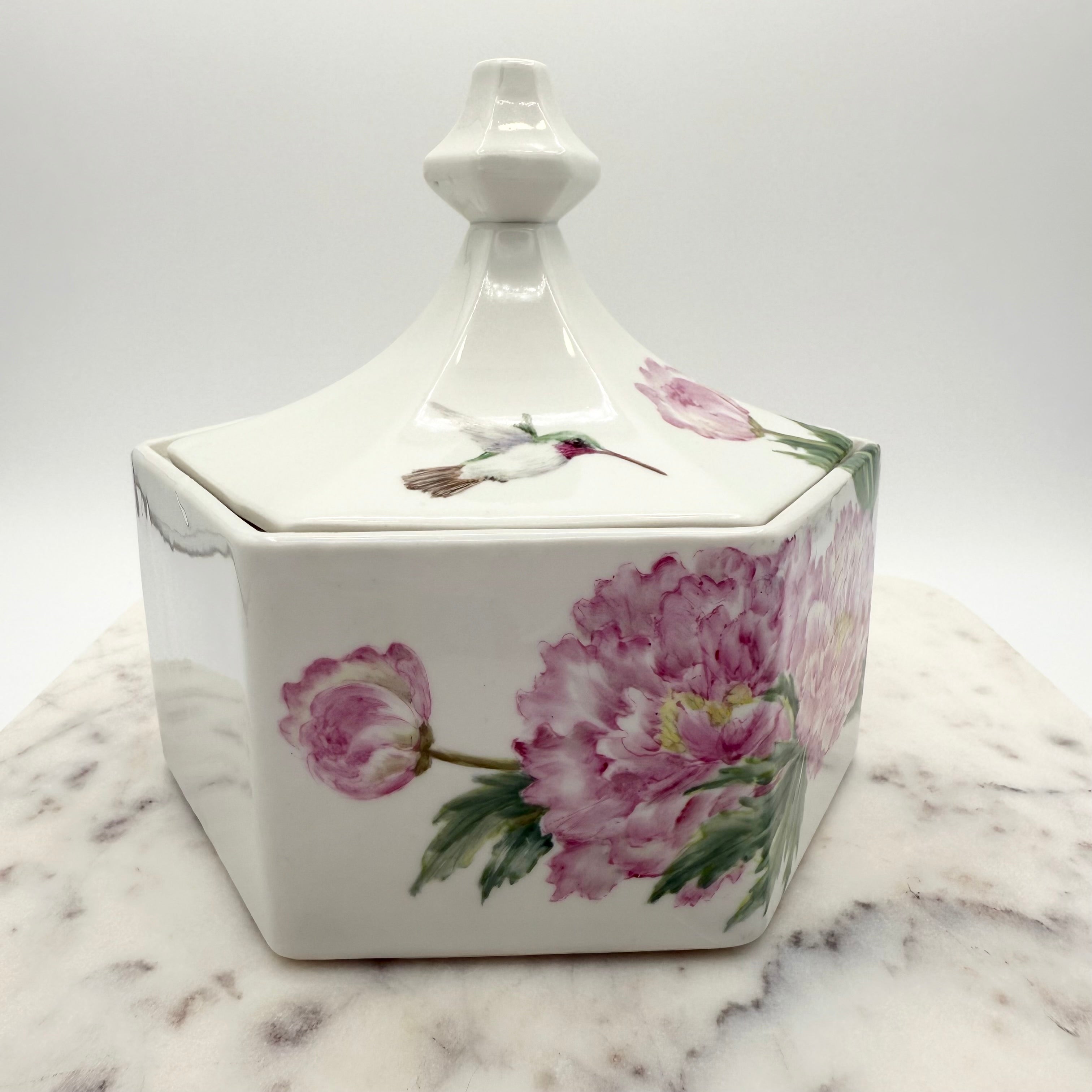 Vintage ceramic lidded box with hand painted peony blossoms. Elegant floral collectible for display or storage.